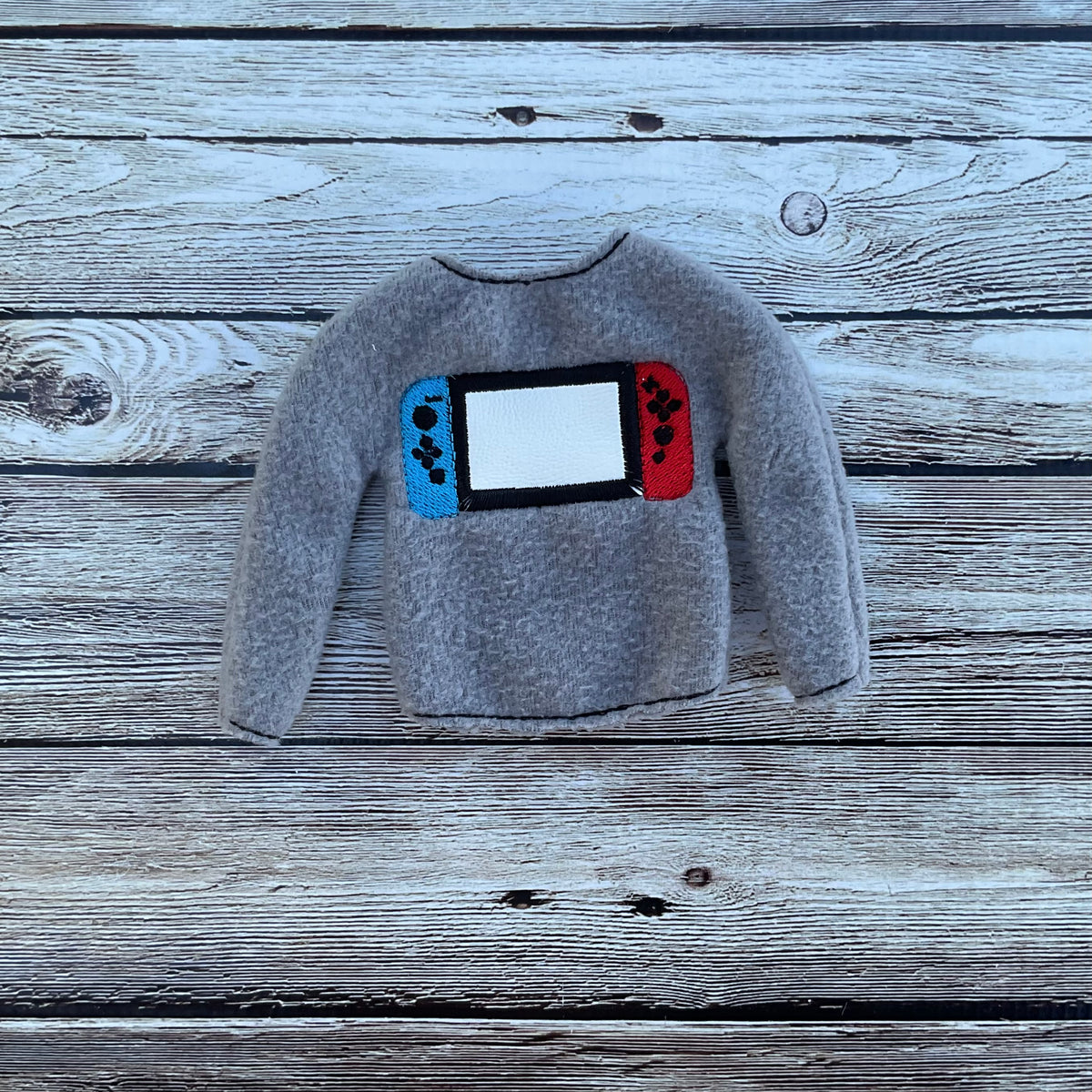 (239) Holiday Elf/Doll Sweater featuring a Game Switch