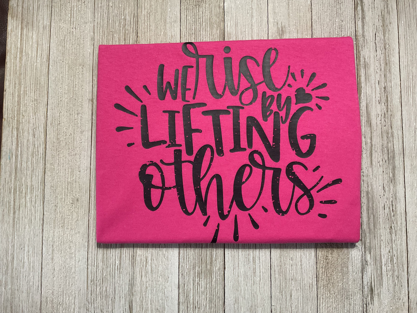 We Rise by Lifting Others Graphic T - Pink